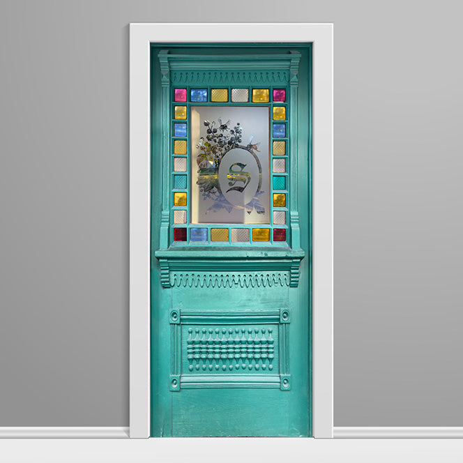 Decorative turquoise door with stained glass design on a gray background