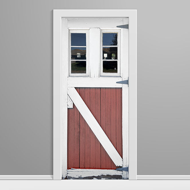 Red barn door with white frame on a gray background