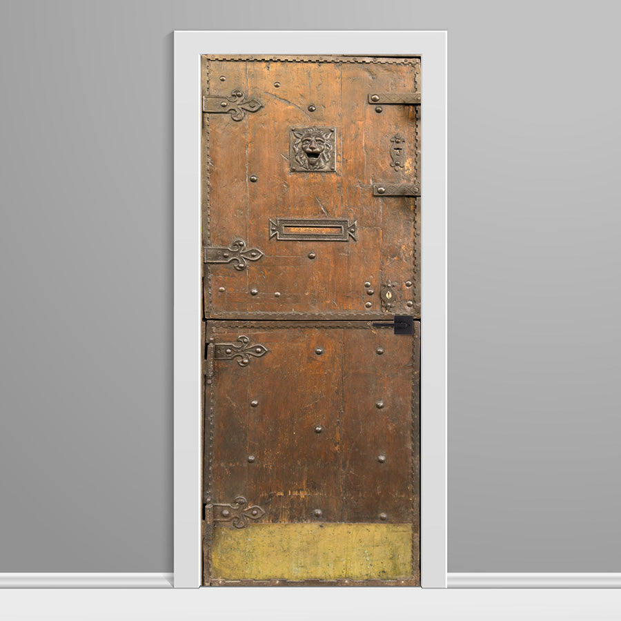 Decorative door with intricate designs on a gray wall
