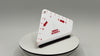 White triangular ruler with red markings and text on a gray background