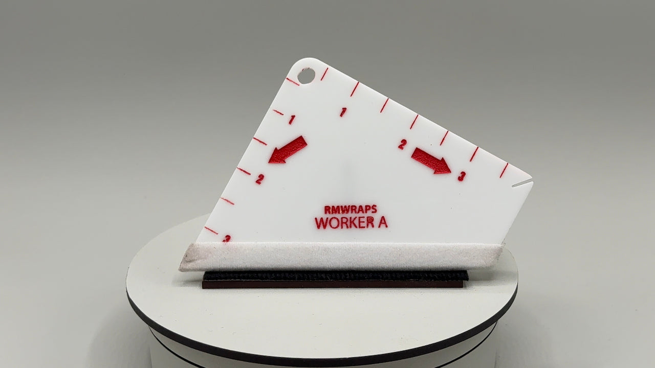 White tool with red markings and text on a gray background