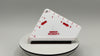 White tool with red markings and text on a gray background