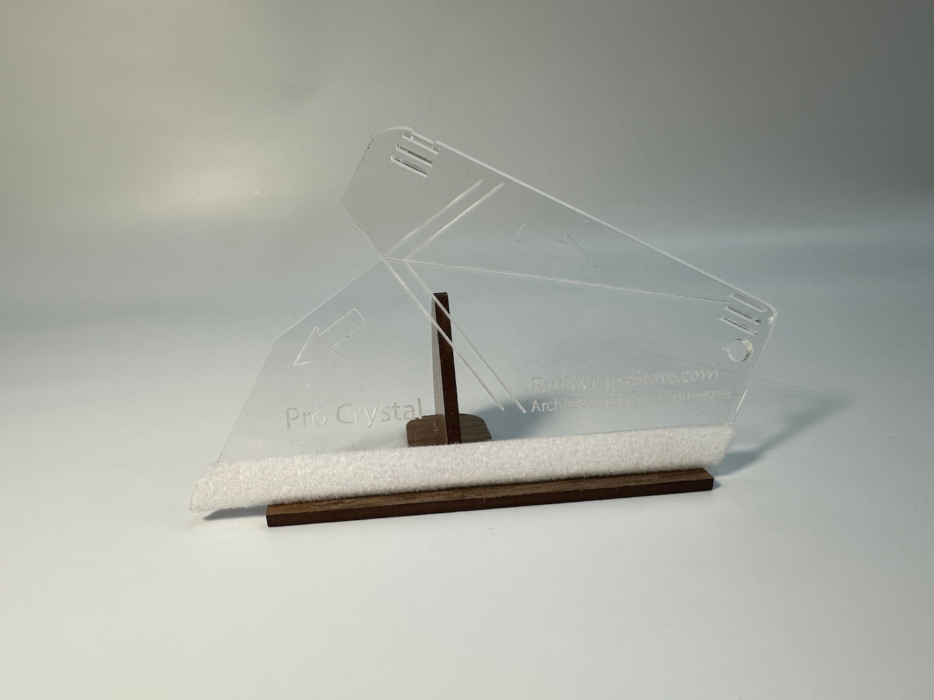 A wooden squeegee with a red microfiber felt surface, featuring guide arrows and a lanyard hole, positioned on a white background.