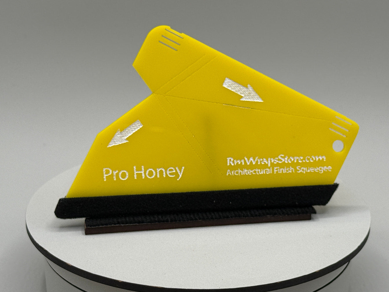 Yellow architectural finish squeegee with 'Pro Honey' branding on a gray background