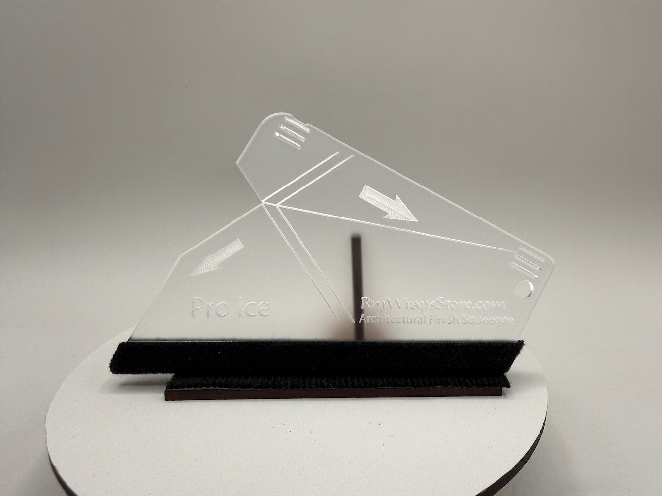Clear acrylic object on a white stand with a gray background