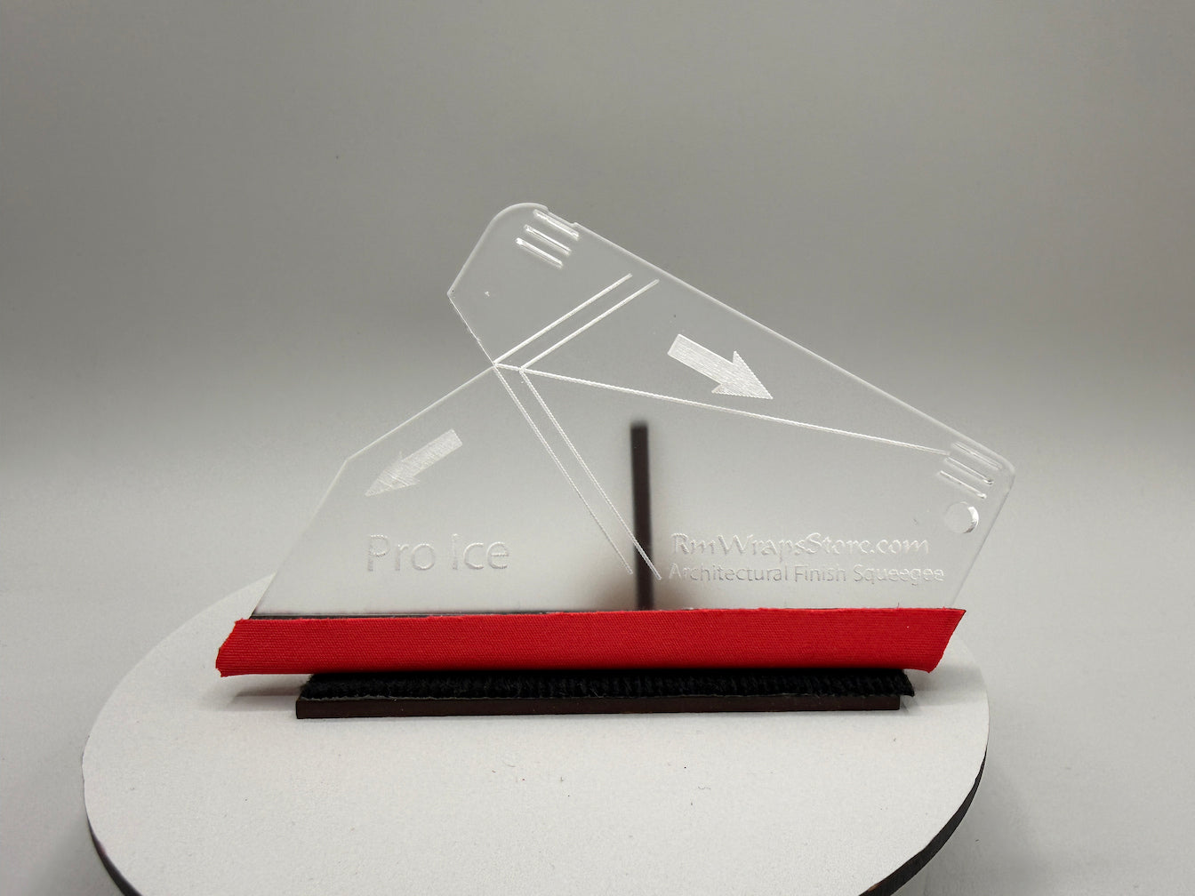 Clear plastic squeegee on a gray background