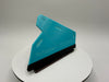 Teal squeegee on a white stand with a gray background