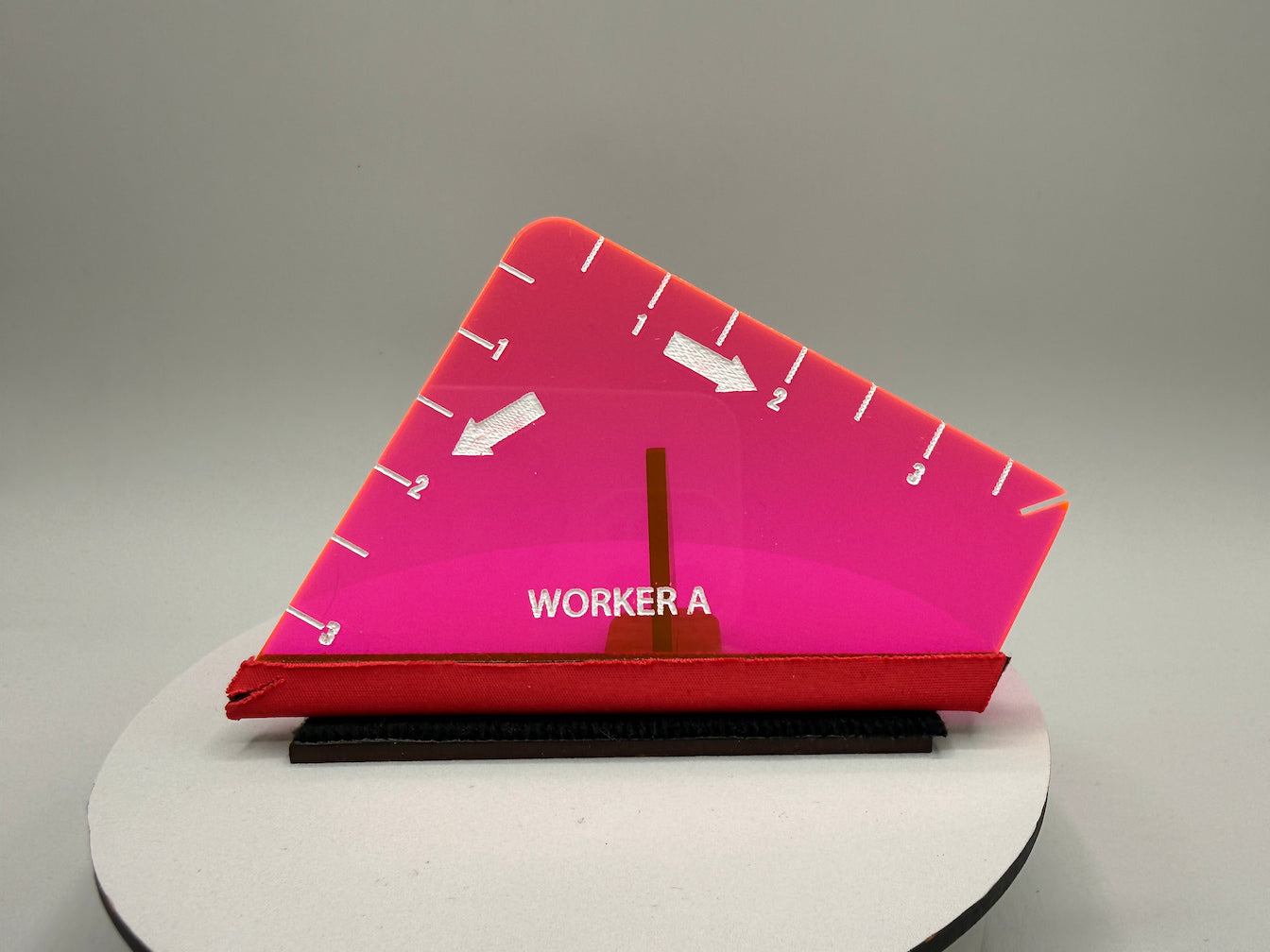 Pink and red triangular tool with 'WORKER A' branding on a gray background