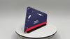 Blue and red tool on a white surface with a gray background