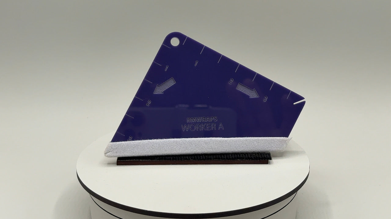 Blue plastic tool with white handle on a gray background