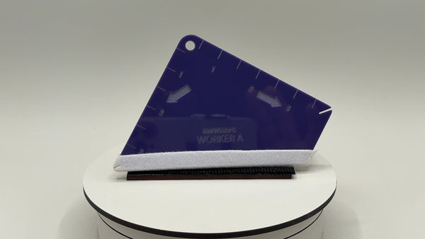 Blue plastic tool with white handle on a gray background