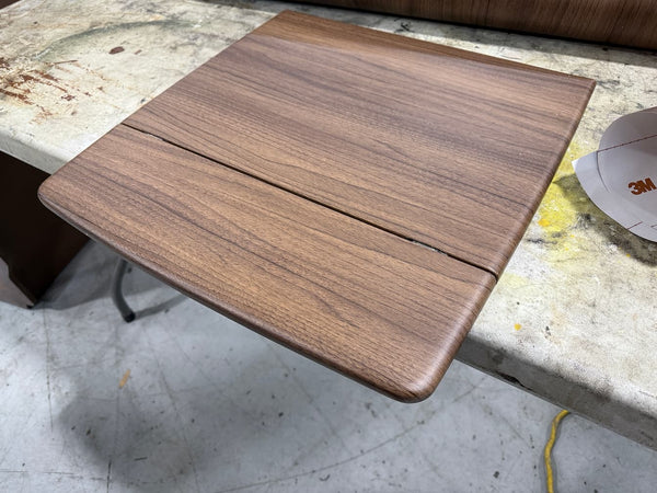 Wooden surface on a concrete floor with a visible crack