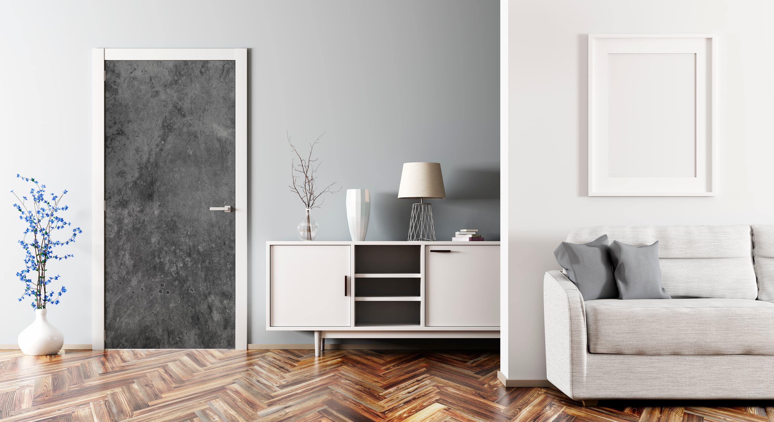 Modern living room with a gray sofa, white cabinet, and framed artwork on a gray wall.