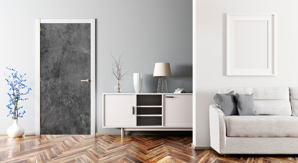 Modern living room with a gray sofa, white cabinet, and framed artwork on a gray wall.