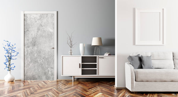 Modern living room with gray sofa, white sideboard, and framed artwork on a gray wall.