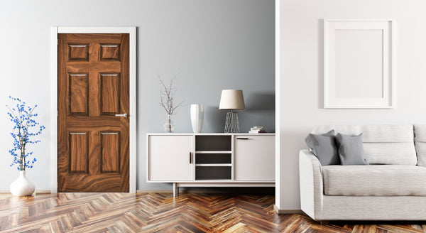 Modern living room with wooden door, white cabinet, and gray sofa.