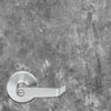 Silver door handle on a textured gray wall